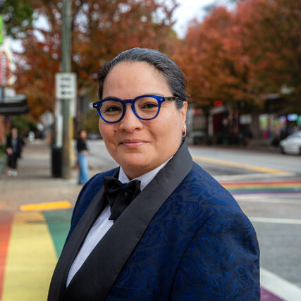 photo of Maria Alvarez standing on the rainbow crosswalks